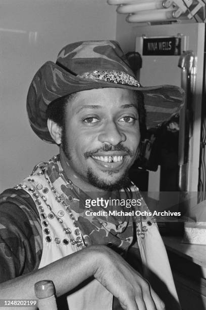 Robert Wilson of The Gap Band, with a gold tooth, at the station of make-up artist Nina Wells, possibly on the television show 'Solid Gold', circa...