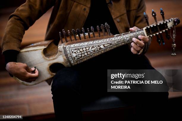 Ramiz, 19 years old, music student from the National Institute of Music of Afghanistan , plays Afghan instrument called rubab, at the Music...