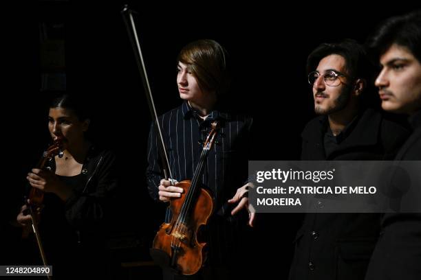 Music students of the National Institute of Music of Afghanistan hold their instruments at the backstage prior to a concert at the Music Conservatory...