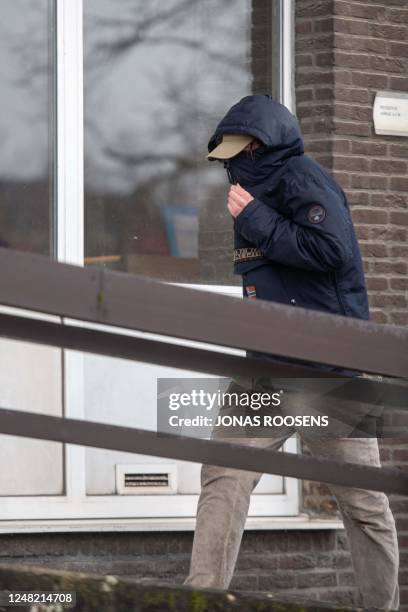 One of the accused hides his face underneath his cap and hood as he arrives for a session of the case before the Antwerp appeal court, a remark of...