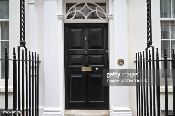 Photograph taken on March 14, 2023 shows the door of Number 11 Downing Street, the official residence of Britain's Chancellor of the Exchequer, in...
