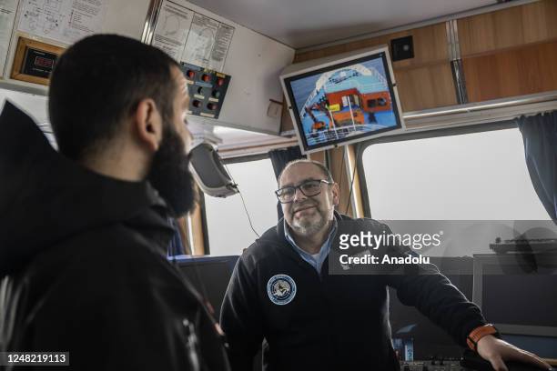 Captain Ozgun Oktar , leader of the 7th National Antarctic Science Expedition, receives briefing from the Betanzos Ship Captain Jose Roman Leopoldo...