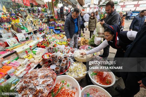 Iranians shop at the Tajrish Bazaar market in the capital Tehran on March 14 in preparation for the celebration of Noruz, the Persian New Year. Noruz...
