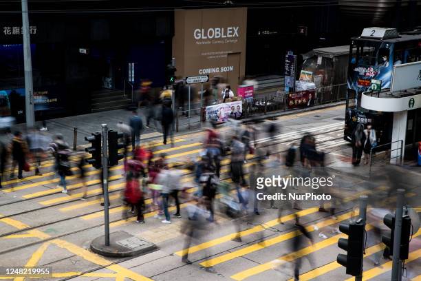 People are crossing the street in Central Hong Kong in this slow shutter speed picture on March 14, 2023.