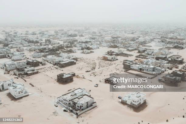 This aerial view shows newly built houses and construction sites in the Saharawi area on the outskirts of Nouakchott, on March 14, 2023.