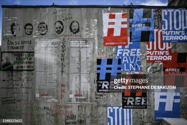 Posters against Russian President Vladimir Putin adorn a mockup of the punishment cell of imprisoned Russian opposition politician Alexei Navalny on...