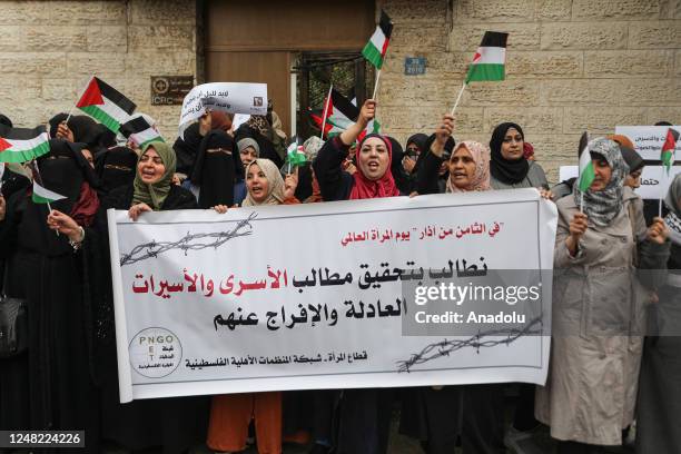 Palestinian women gather in front of the International Committee of the Red Cross building in Gaza to demonstrate in support for Palestinian women...