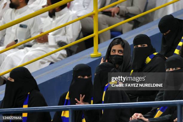 Women fans of Al-Nassr FC attend their team's King Cup quarter-final football match against Abha FC at Mrsool Park Stadium in Riyadh on March 14,...