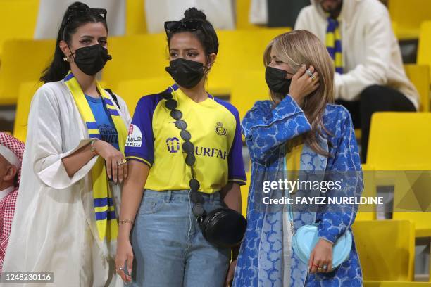 Women fans of Al-Nassr FC attend their team's King Cup quarter-final football match against Abha FC at Mrsool Park Stadium in Riyadh on March 14,...