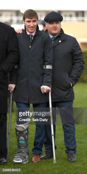 Gloucestershire , United Kingdom - 14 March 2023; Injured jockey Jack Kennedy, left, and trainer Gordon Elliott after sending out Jazzy Matty to win...