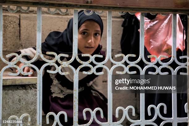 Girl waits to be dispensed medication from a free pharmacy at al-Janatain Charity Medical Centre, which helps the impoverished, in Yemen's...