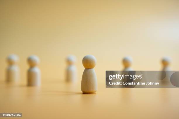 standing out from the crowd and leadership concept with wooden figurines. - vision and mission stock-fotos und bilder