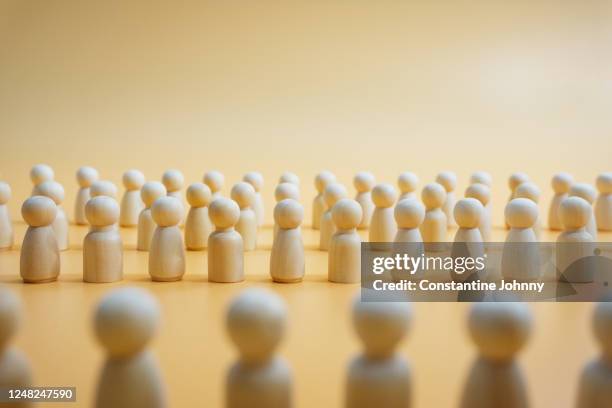 united. wooden figurines standing together to face authority. - democracy stock pictures, royalty-free photos & images