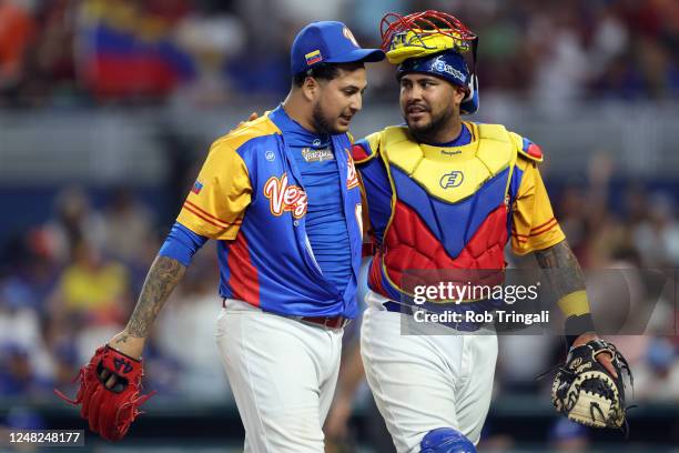 José Quijada and Omar Narváez of Team Venezuela walk off the field after the eighth inning of Game 7 of Pool D between Team Nicaragua and Team...