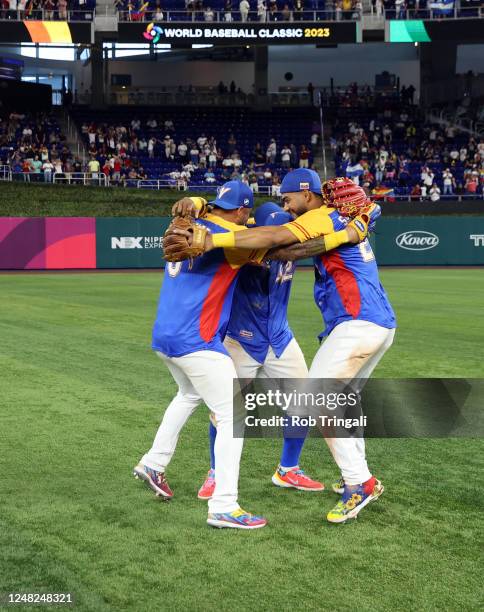 Ronald Acuña Jr. #42, Anthony Santander and David Peralta of Team Venezuela celebrate after winning Game 7 of Pool D between Team Nicaragua and Team...