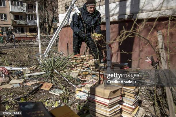 Peter, a local civilian collects books from an apartment following an explosion of a missile strike in a residential area that left one person dead...