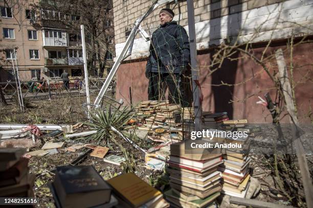 Peter, a local civilian collects books from an apartment following an explosion of a missile strike in a residential area that left one person dead...