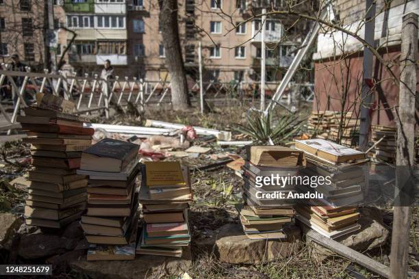 Books collected from an apartment by a local named Peter , are seen piled following an explosion of a missile strike in a residential area that left...