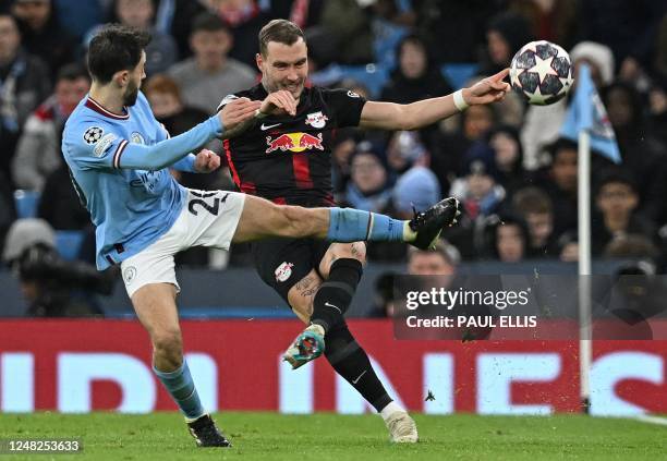 Leipzig's German midfielder David Raum vies with Manchester City's Portuguese midfielder Bernardo Silva during the UEFA Champions League round of 16...