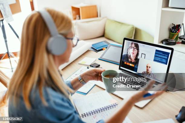 mature businesswoman working from home during pandemic and attending video call meeting - virtual presentation stock pictures, royalty-free photos & images