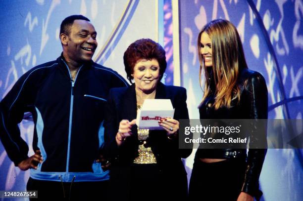 Cilla Black, Lenny Henry with guest date Elle McPherson during the Blind Date sketch during Red Nose Day on March 12, 1999 in London, England.