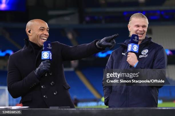 Thierry Henry laughs and smiles with Erling Haaland of Manchester City after the UEFA Champions League round of 16 leg two match between Manchester...
