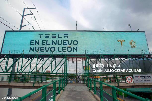 Billboard announcing the arrival of the American electric car maker Tesla is seen in Monterrey, state of Nuevo Leon, Mexico, on March 12, 2023. -...