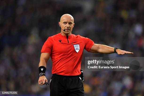 Referee Szymon Marciniak gestures during the UEFA Champions League round of 16 leg two match between FC Porto and FC Internazionale at Estadio do...