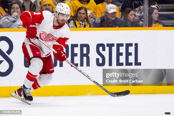 Filip Zadina of the Detroit Red Wings passes the puck during the first period against the Nashville Predators at Bridgestone Arena on March 14, 2023...