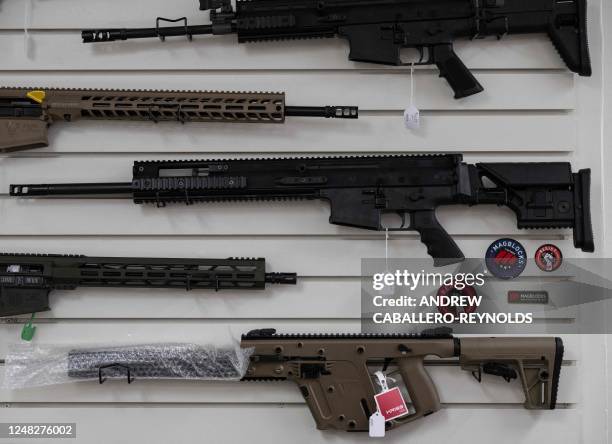 Guns are seen for sale on a wall at EJB's Gun Shop in Capitol Heights, Maryland on March 14, 2023. - EJB's Gun Shop has been open for 3 years and is...