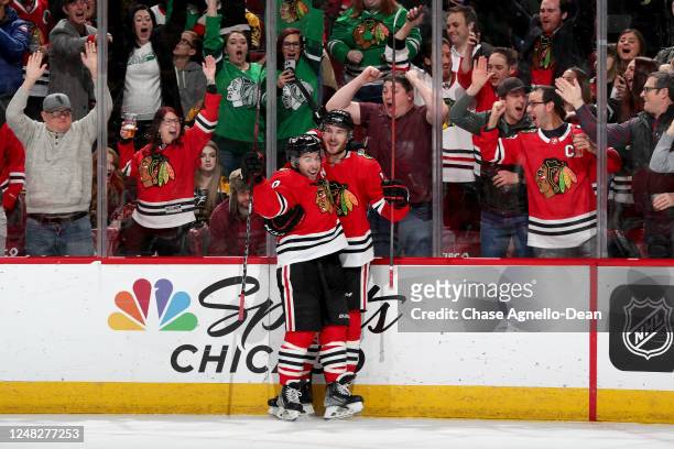 Taylor Raddysh and Tyler Johnson of the Chicago Blackhawks celebrate after Raddysh scores against the Boston Bruins in the third period at United...