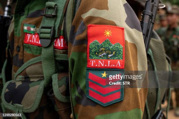 In this photo taken on March 9, 2023 the logo of the ethnic rebel group Ta'ang National Liberation Army is pictured on a member's uniform near...