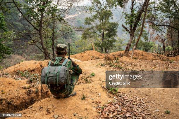 In this photo taken on March 9, 2023 a member of ethnic rebel group Ta'ang National Liberation Army guards a checkpoint near Namhsan Township in...