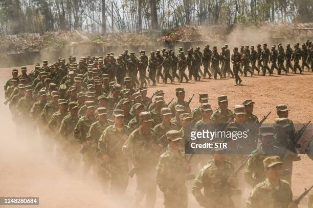 In this photo taken on March 8, 2023 members of ethnic rebel group Ta'ang National Liberation Army take part in a training exercise at their base...