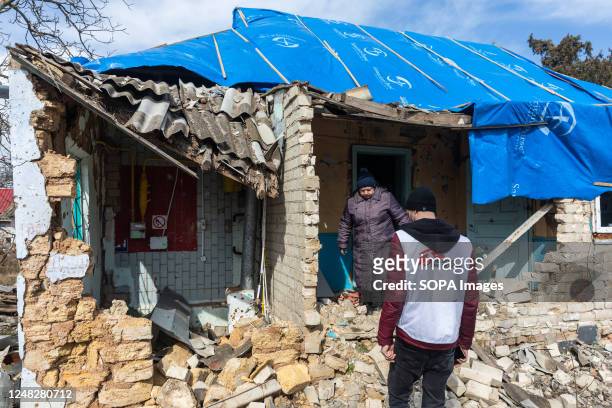 Volunteer from the humanitarian mission Doctors Without Borders (Médecins Sans Frontières inspects a destroyed house on the outskirts of Kherson.