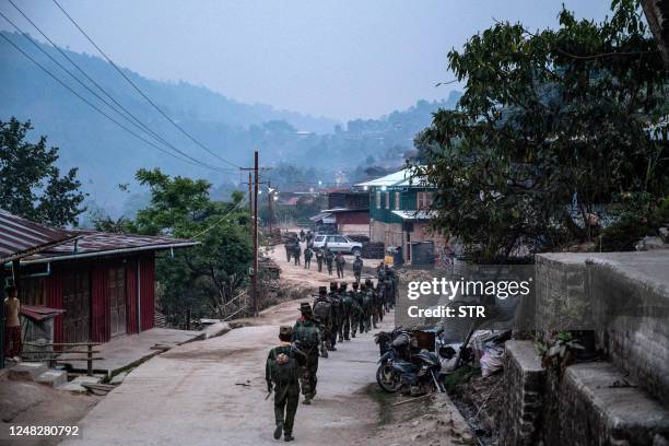 In this photo taken on March 9, 2023 members of ethnic rebel group Ta'ang National Liberation Army patrol near Namhsan Township in Myanmar's northern...