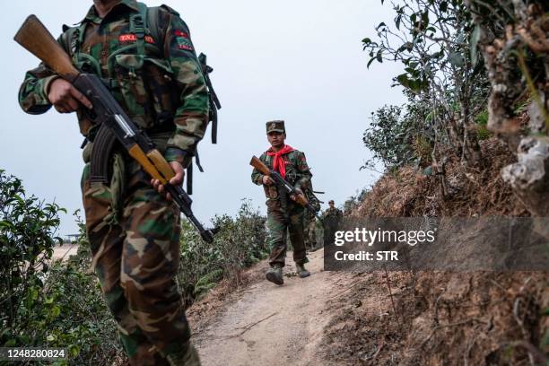 In this photo taken on March 9, 2023 members of ethnic rebel group Ta'ang National Liberation Army patrol near Namhsan Township in Myanmar's northern...