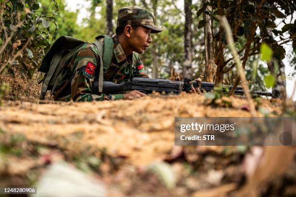 In this photo taken on March 9, 2023 a member of ethnic rebel group Ta'ang National Liberation Army guards a checkpoint near Namhsan Township in...