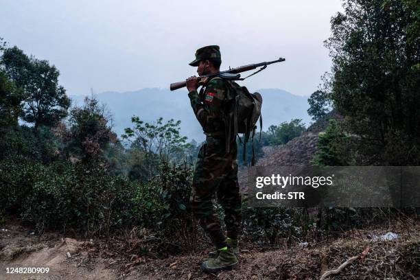 In this photo taken on March 9, 2023 a member of ethnic rebel group Ta'ang National Liberation Army patrols near Namhsan Township in Myanmar's...