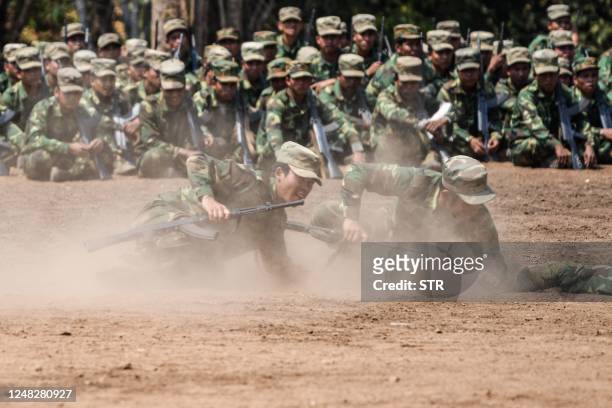 In this photo taken on March 8, 2023 members of ethnic rebel group Ta'ang National Liberation Army take part in a training exercise at their base...