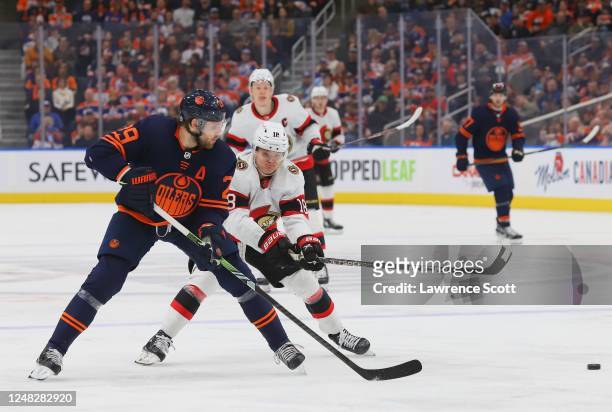 Tim Stutzle of the Ottawa Senators battles for the puck with Leon Draisaitl of the Edmonton Oilers in the third period on March 14, 2023 at Rogers...