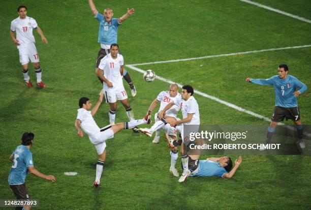 Egyptian defender Ahmed Said shoots past Italian defender Fabio Cannavaro , Egyptian defender Ahmed Hassan , Italian midfielder Daniele de Rossi ,...