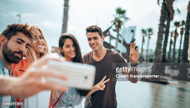 happiness friends taking a selfie embracing  outdoors - barceloneta beach stock pictures, royalty-free photos & images