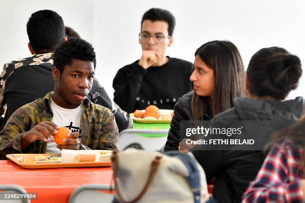 African and Tunisian students sit at the cafeteria in the campus of ESPRIT university, specialised in engineering and management courses, on March...