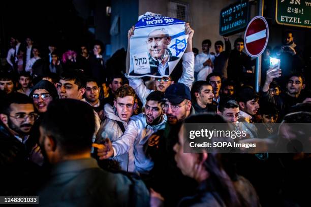 Ultra Orthodox Jewish youth holds a placard showing the portrait of Israeli Prime Minster Benjamin Netanyahu during an anti Judicial reform protest....