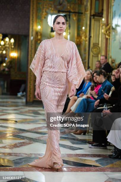 Model showcases creations by AMARCA during the Atelier Couture bridal catwalk within Madrid Fashion Week, held at Santa Isabel Palace in Madrid.