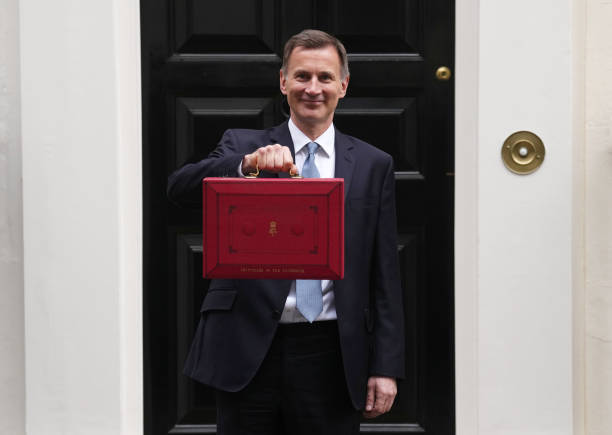 Chancellor Jeremy Hunt leaves Downing Street with the despatch box to present his spring budget to parliament on March 15, 2023 in London, England....