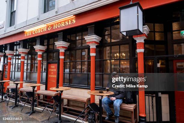 Man outisde the famous Coach and Horses pub in Soho on 9th March 2023 in London, United Kingdom. The Coach & Horses is a historic haunt for...
