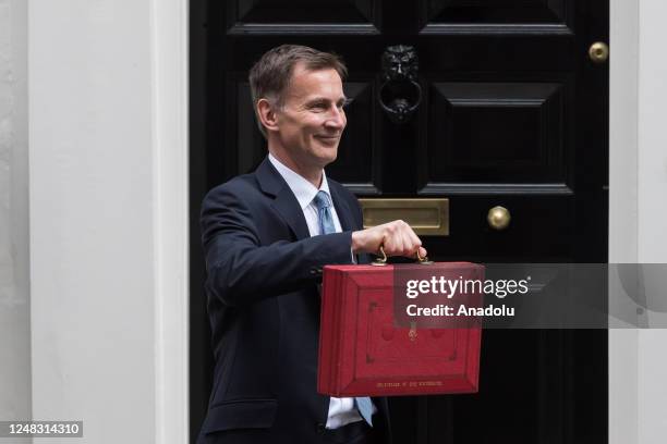 Britain's Chancellor of the Exchequer Jeremy Hunt holds the Budget box outside 11 Downing Street ahead of the announcement of the Spring Budget in...