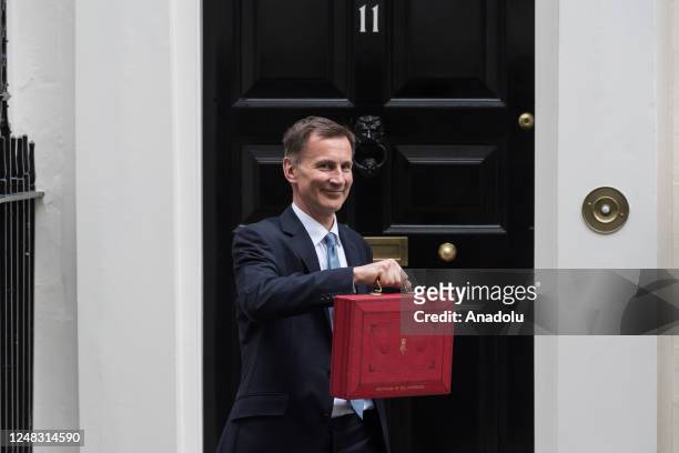 Britain's Chancellor of the Exchequer Jeremy Hunt holds the Budget box outside 11 Downing Street ahead of the announcement of the Spring Budget in...